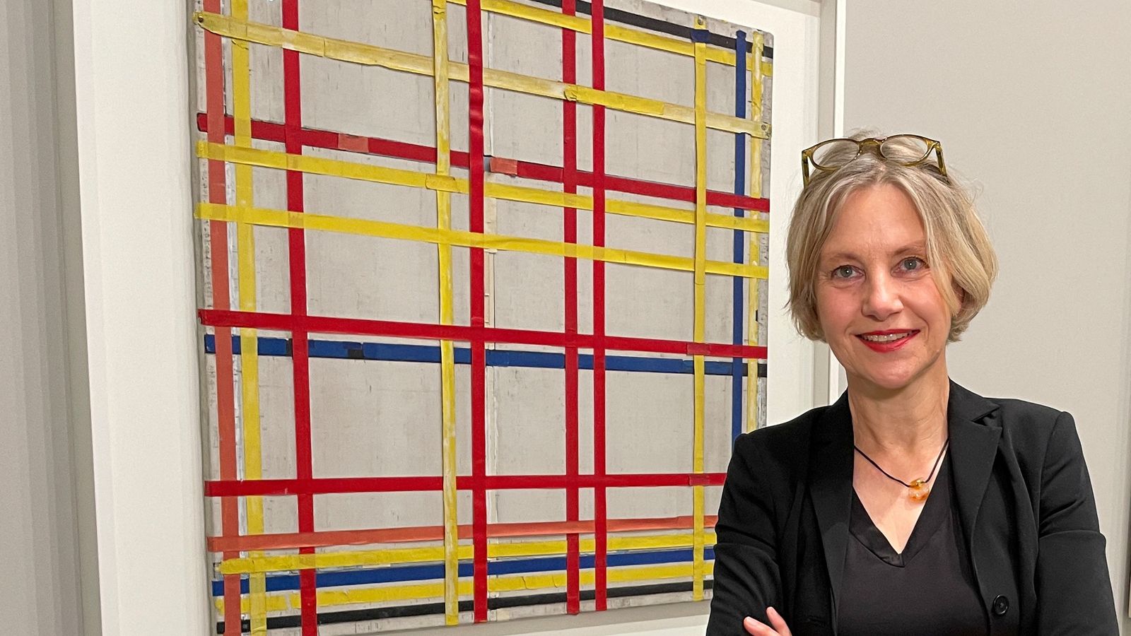 Curator Susanne Meyer-Bueser poses in front of the Piet Mondrian painting "New York City I" in the Kunstsammlung NRW after it has been hanging upside down for 77 years in Duesseldorf, Germany, October 28, 2022. REUTERS/Petra Wischgoll NO RESALES. NO ARCHIVES